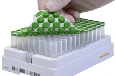 An uncovered 96-well format rack of internally threaded tubes precapped with a green TPE capmat